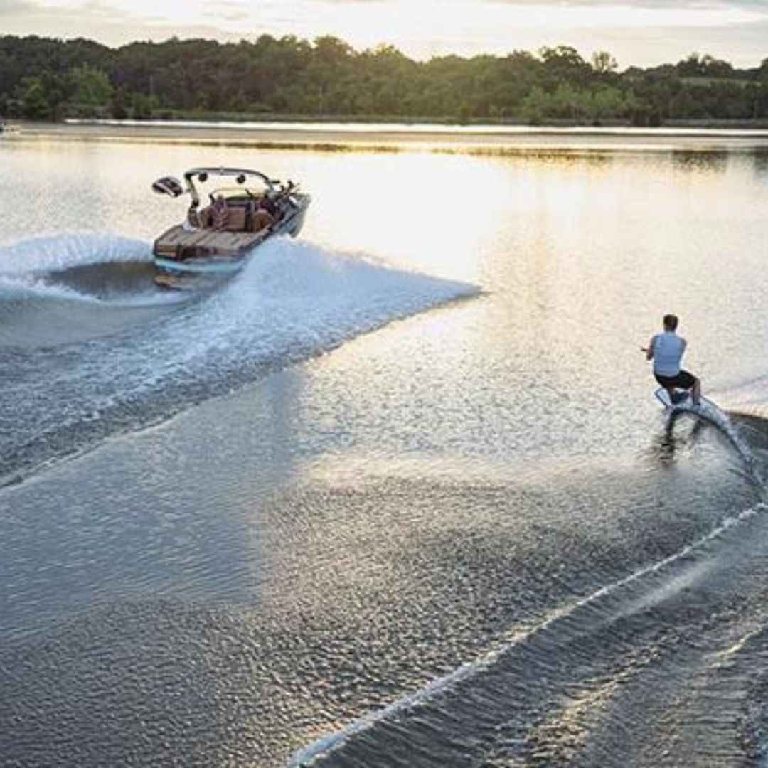 MasterCraft XT auf einem See mit einem Wakeboarder